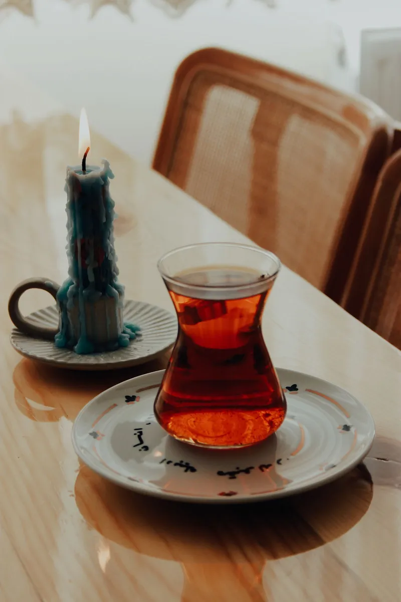 A cup of tea on a table at home by a window